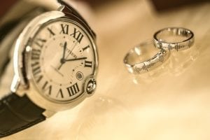 two wedding rings and a ticking clock