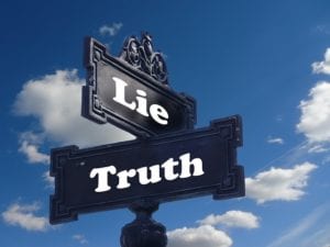 Signs saying "Lie" and "Truth"