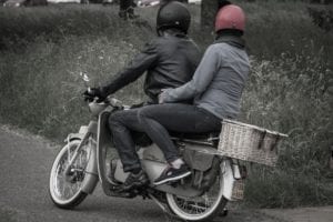 Young couple ridding motorcycle together