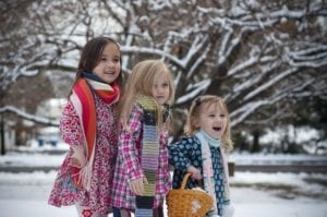Young girls playing in snow together