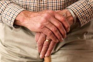 Close up of old man holding cane