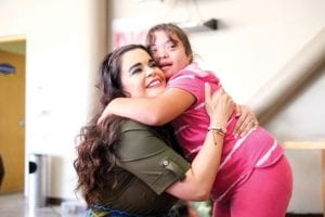 Mother hugging her disabled daughter
