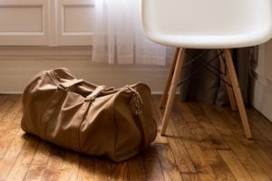 Packed luggage bag sitting on floor